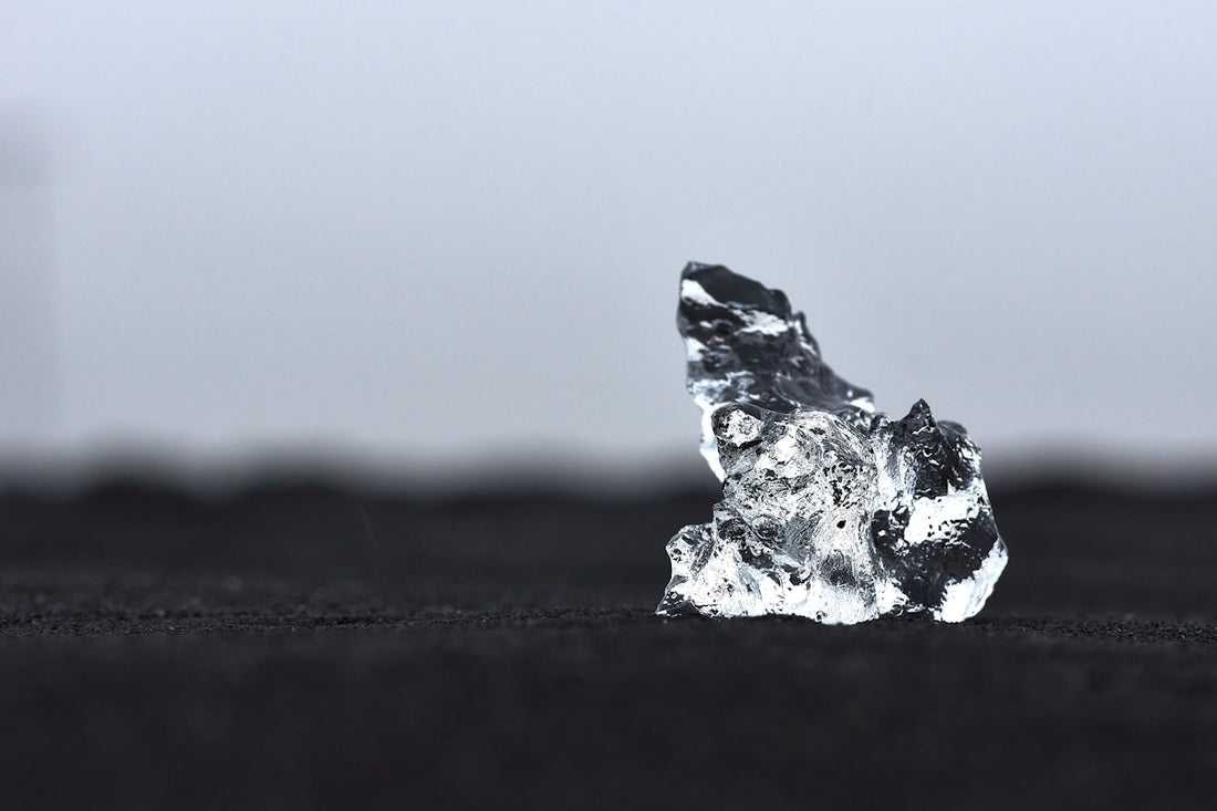 a piece of ice sitting on top of a black surface