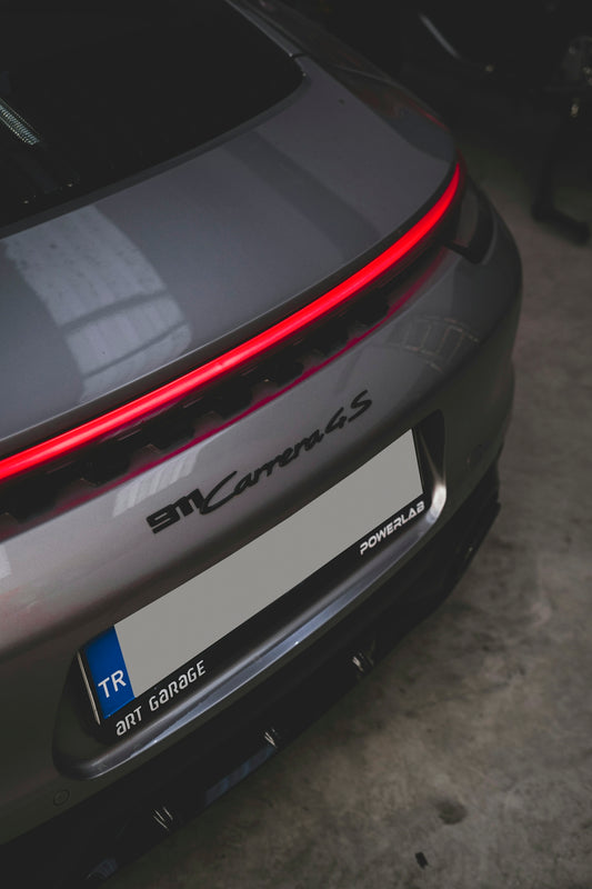 the rear end of a grey sports car