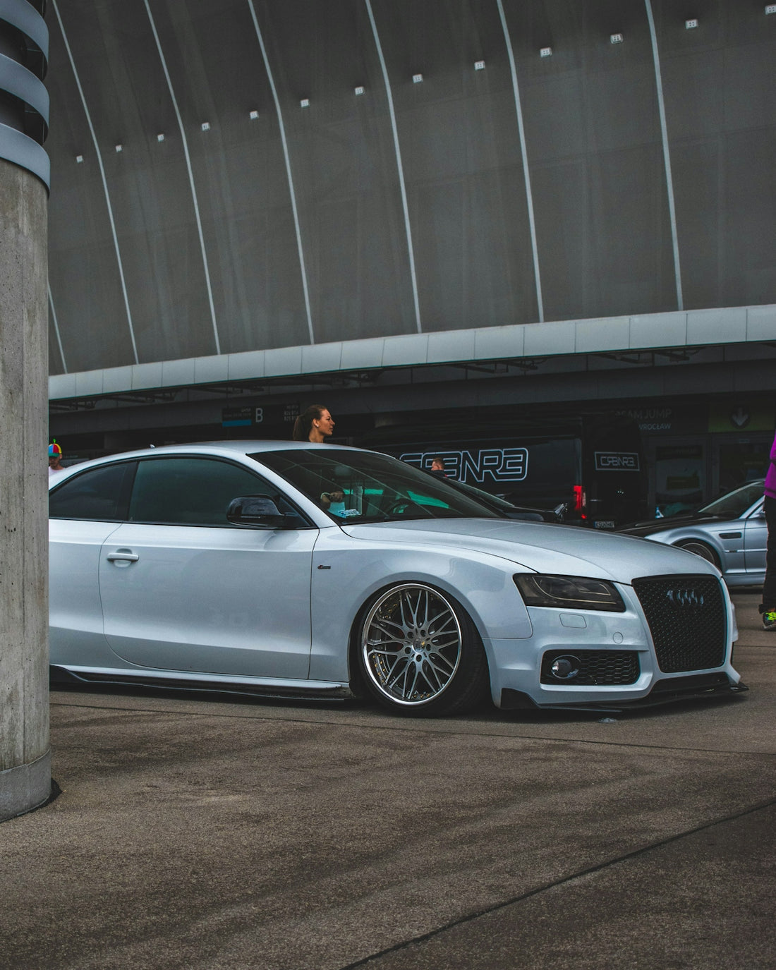 a silver car parked in front of a building