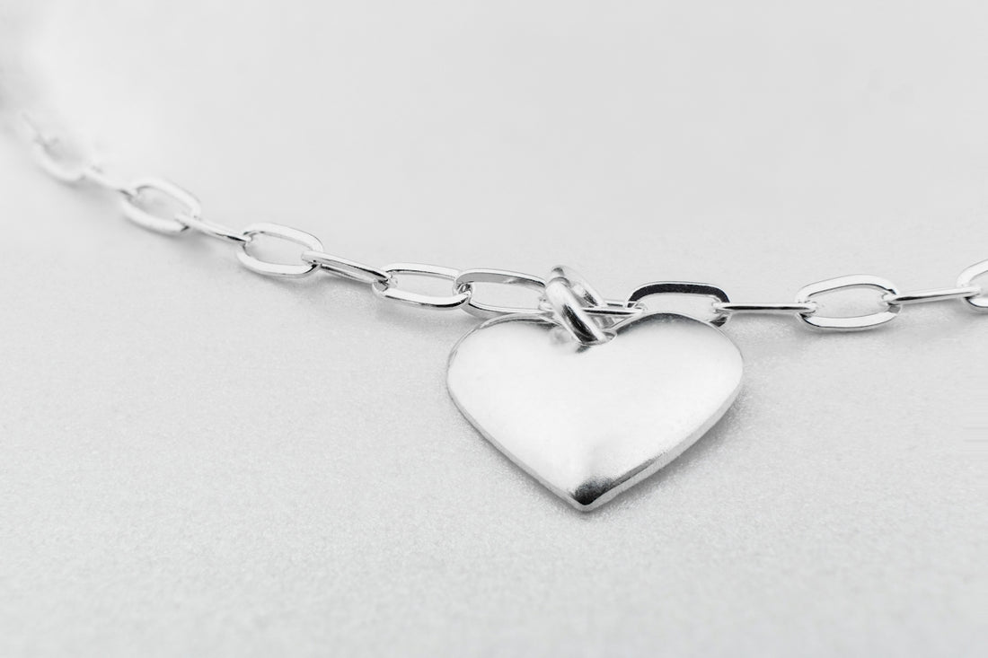 a silver heart charm on a silver chain