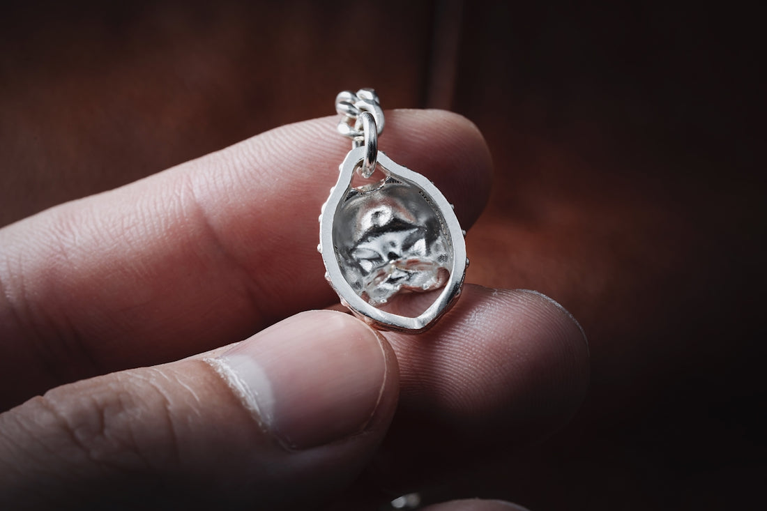 a person holding a silver ring in their hand