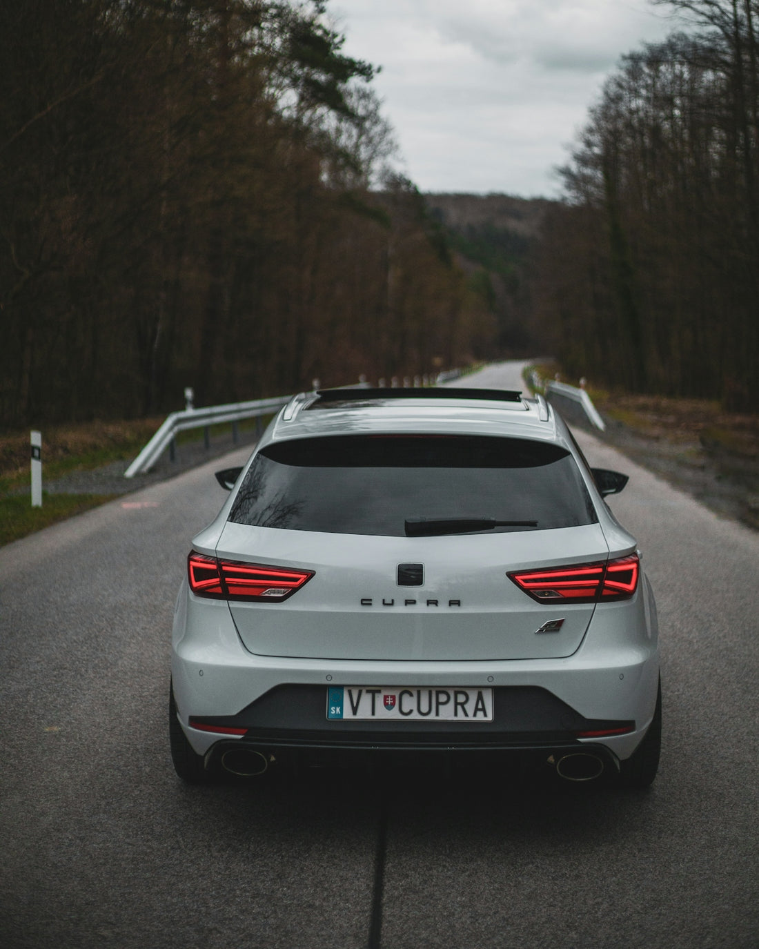 a silver car parked on the side of a road