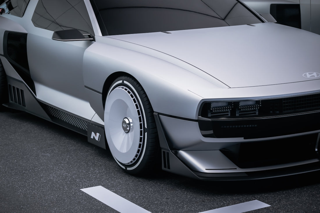 A silver car is parked in a parking lot