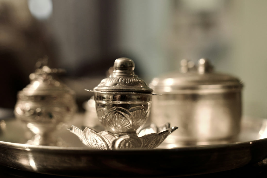 A silver plate with a tea pot on top of it